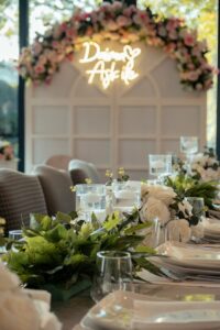 Beautifully decorated wedding reception table with elegant floral arrangements and place settings.